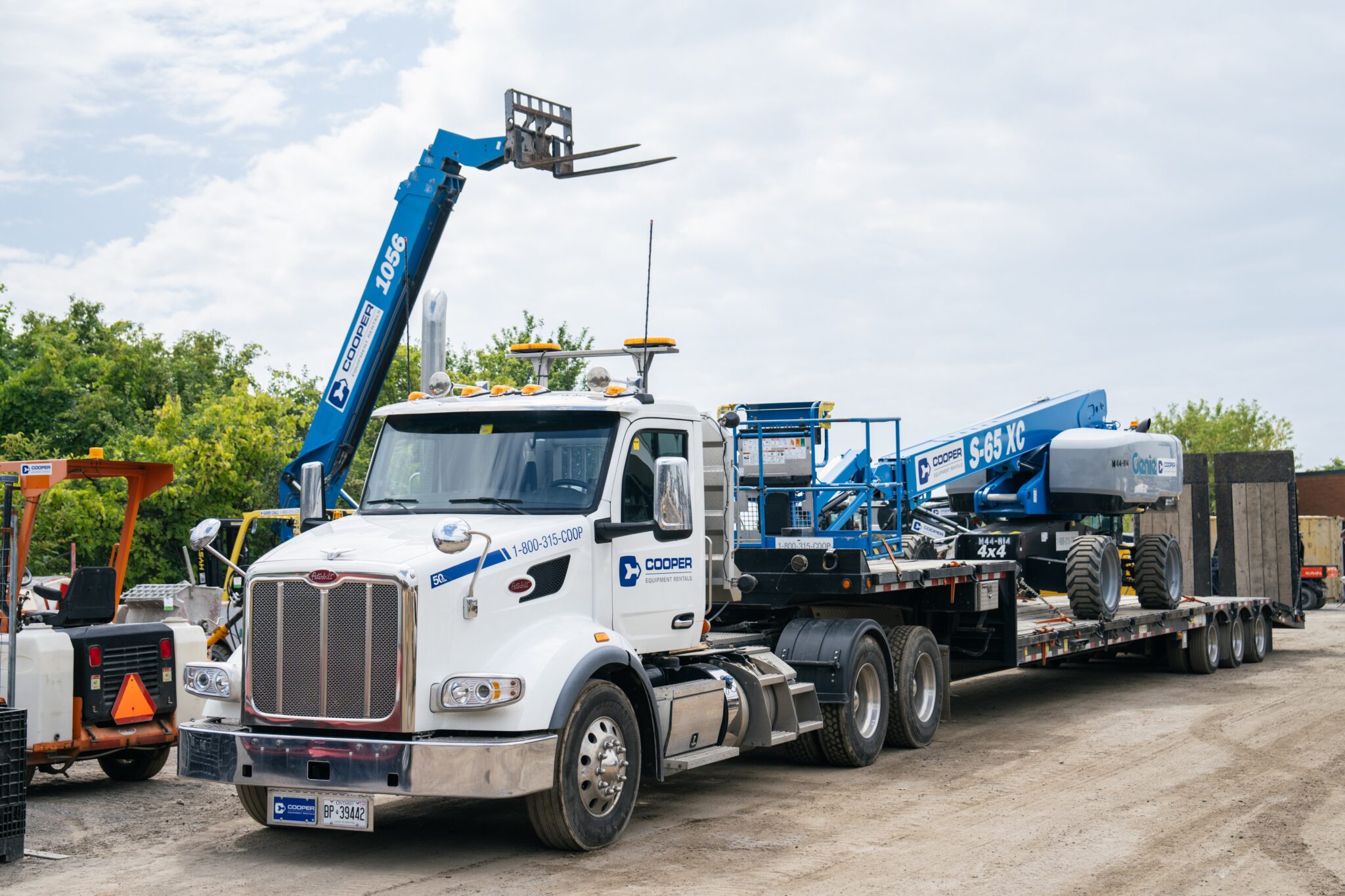 Cooper Equipment Rentals' delivery truck with equipment on it.